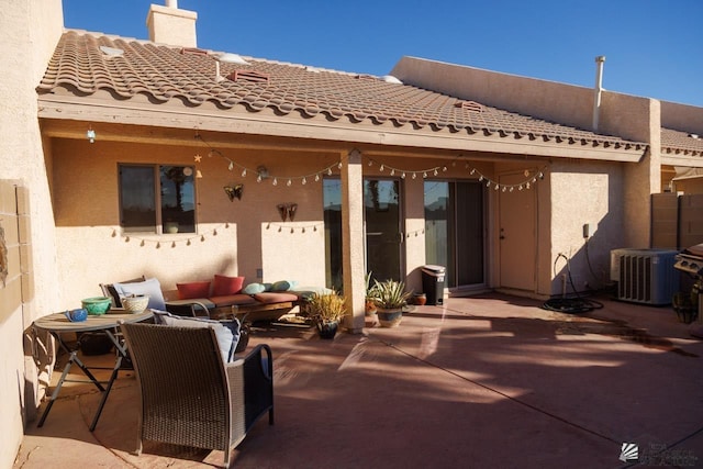 rear view of property with a patio and central AC unit