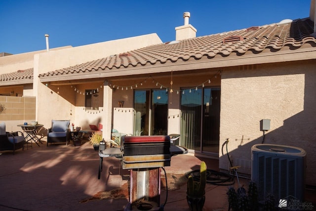 back of house with a patio and central AC unit