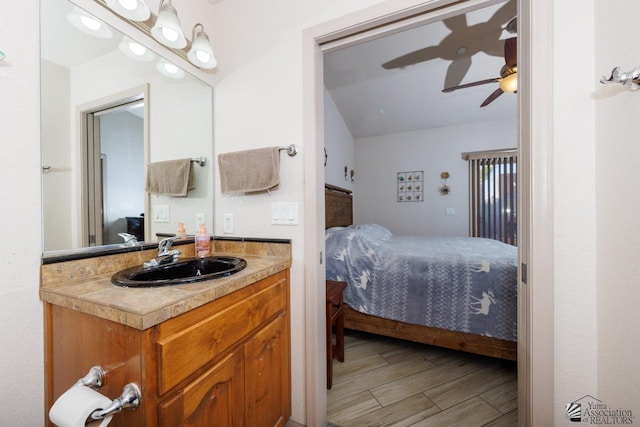 bedroom featuring ceiling fan and sink