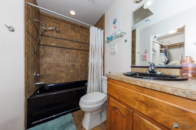 full bathroom featuring tile patterned floors, shower / tub combo with curtain, vanity, and toilet