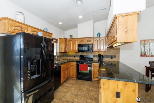 kitchen featuring black appliances, sink, kitchen peninsula, and backsplash