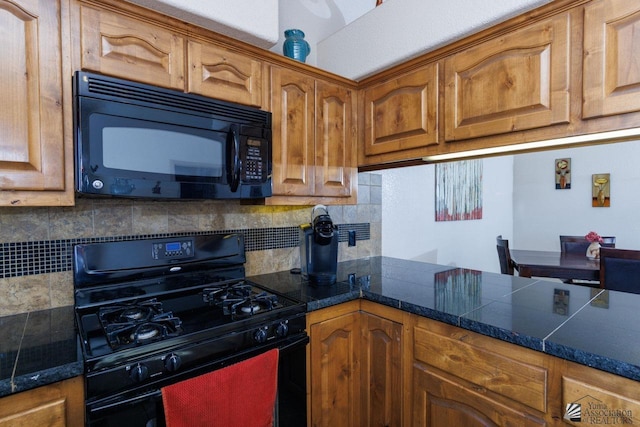 kitchen featuring tasteful backsplash and black appliances