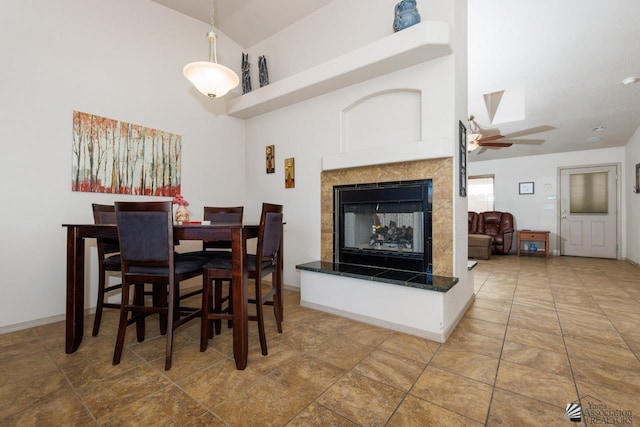 dining space featuring a fireplace and ceiling fan