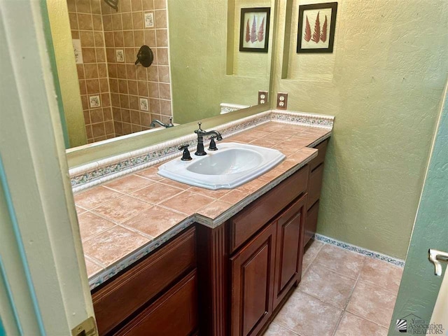 bathroom with tile patterned flooring and vanity