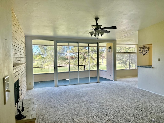 unfurnished living room featuring ceiling fan, a fireplace, and carpet flooring