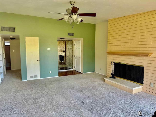 unfurnished living room with a fireplace, carpet floors, and ceiling fan