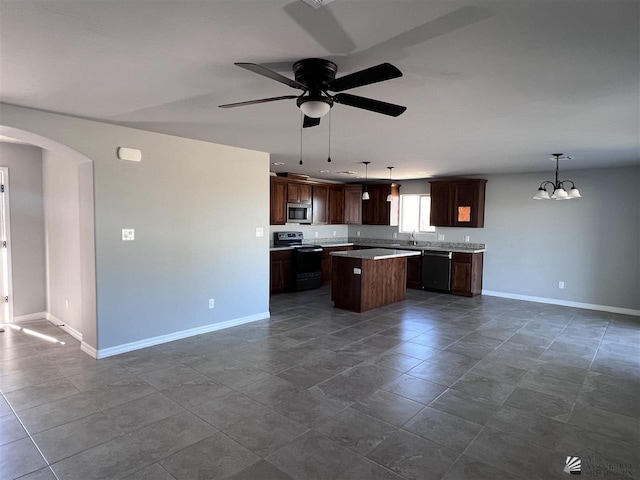 kitchen featuring pendant lighting, dishwasher, ceiling fan with notable chandelier, a kitchen island, and electric range oven