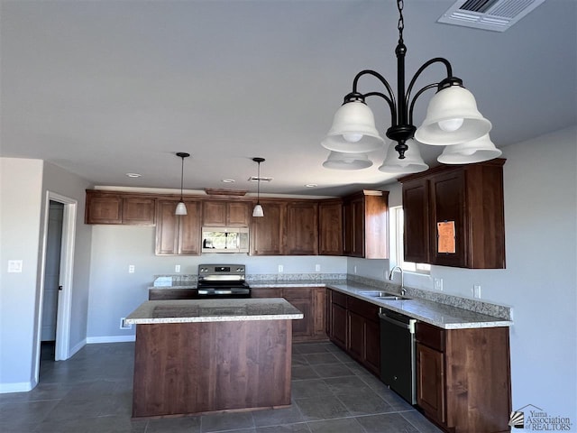 kitchen featuring sink, a chandelier, pendant lighting, a kitchen island, and black appliances