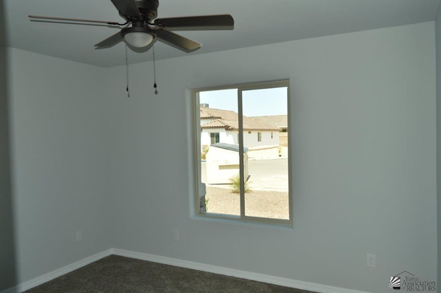 empty room featuring carpet floors and ceiling fan