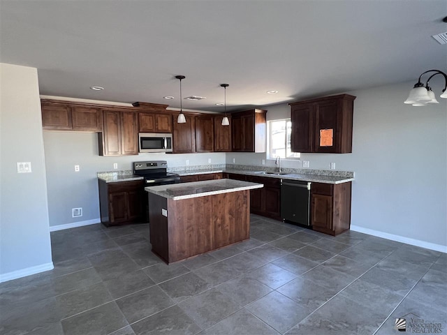 kitchen featuring sink, hanging light fixtures, a kitchen island, dark brown cabinetry, and stainless steel appliances