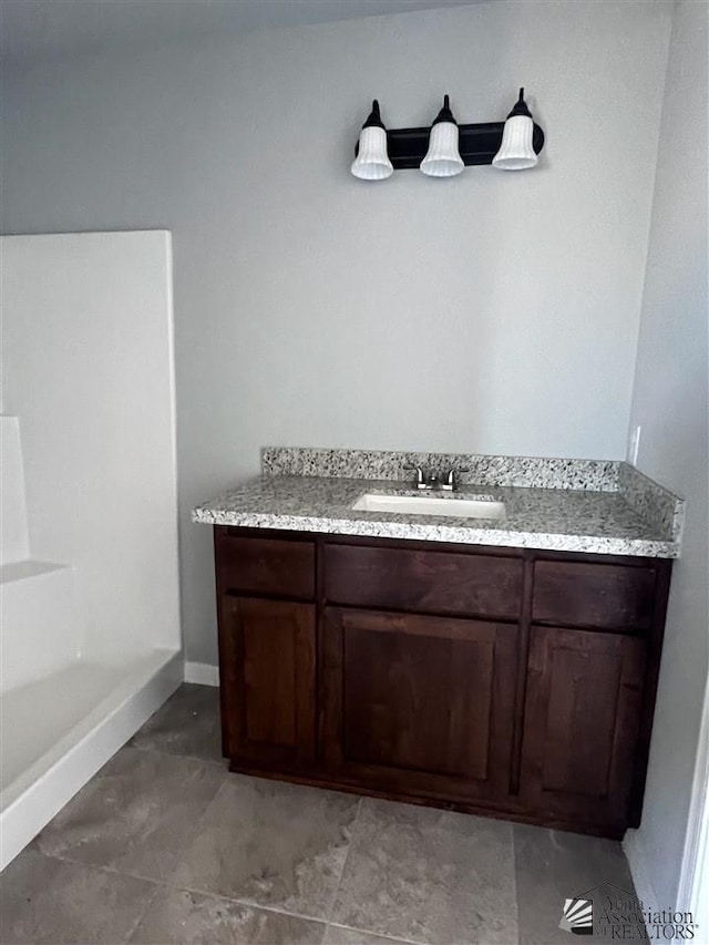 bathroom with tile patterned flooring and vanity