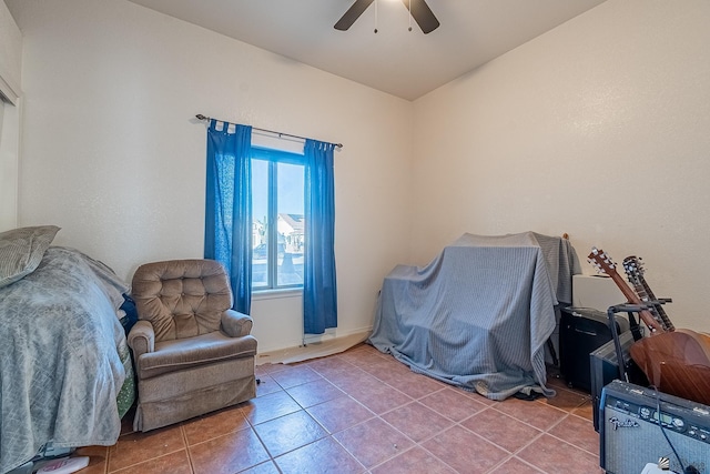 living area with tile patterned flooring, ceiling fan, and vaulted ceiling