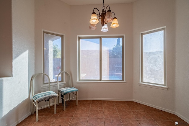 sitting room featuring tile patterned floors and an inviting chandelier