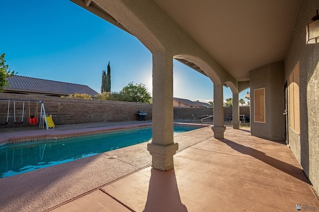 view of swimming pool featuring a patio area