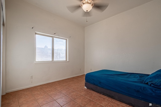 unfurnished bedroom with ceiling fan and tile patterned flooring