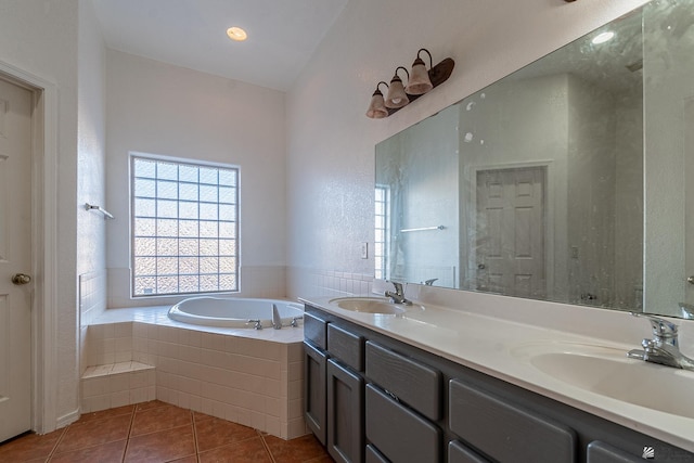 bathroom featuring tile patterned floors, vanity, and plus walk in shower