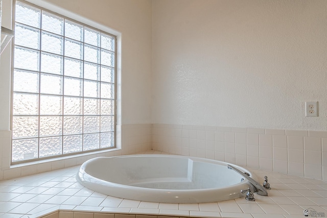 bathroom with tiled tub