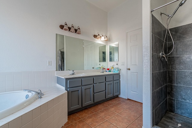 bathroom with tile patterned flooring, vanity, and shower with separate bathtub