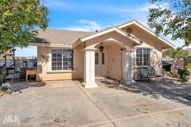 rear view of property featuring a patio area