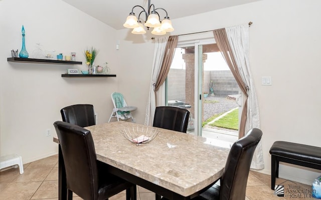 dining area featuring light tile patterned floors, baseboards, and an inviting chandelier