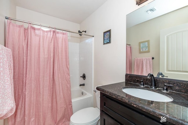 bathroom featuring toilet, shower / bath combo, vanity, and visible vents