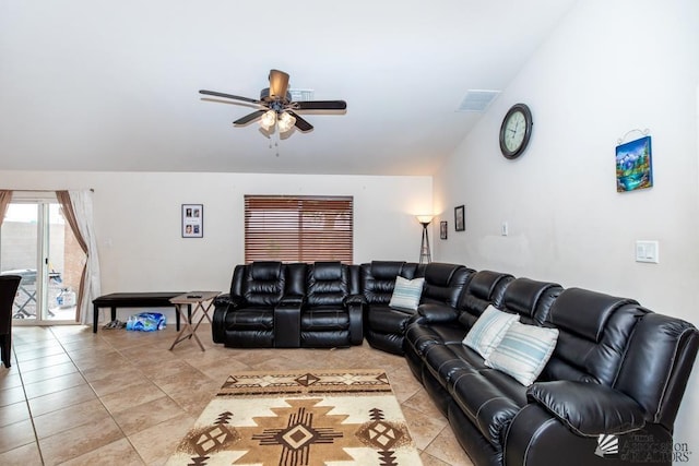 living area featuring light tile patterned floors, ceiling fan, visible vents, and vaulted ceiling