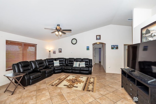 living room with visible vents, arched walkways, a ceiling fan, lofted ceiling, and light tile patterned flooring