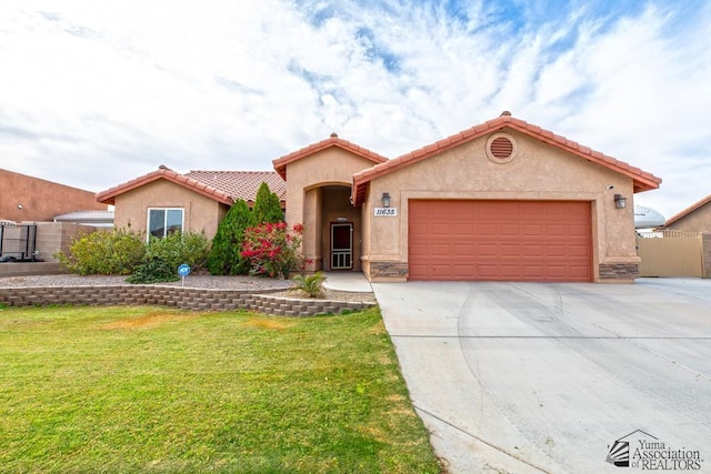 mediterranean / spanish house featuring an attached garage, fence, driveway, stucco siding, and a front lawn