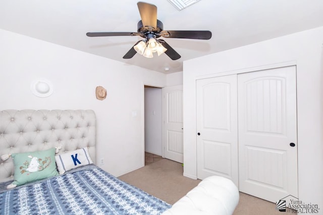 carpeted bedroom featuring a closet, visible vents, ceiling fan, and baseboards