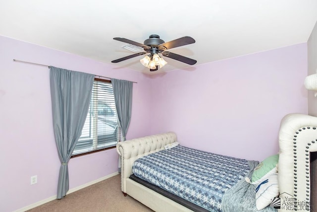 bedroom with ceiling fan, carpet flooring, and baseboards