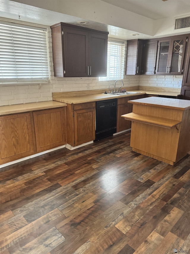 kitchen featuring dark hardwood / wood-style floors, black dishwasher, sink, and dark brown cabinetry