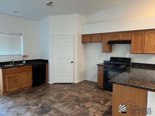 kitchen featuring sink, dark stone counters, and black appliances