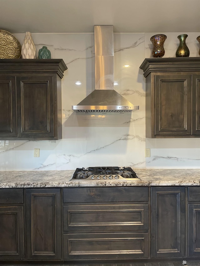 kitchen featuring tasteful backsplash, island exhaust hood, dark brown cabinetry, and stainless steel gas cooktop