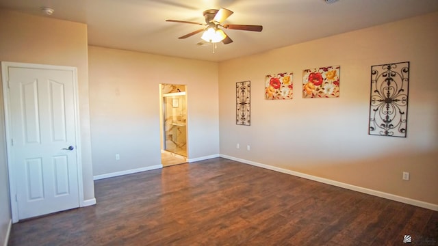 unfurnished bedroom with dark wood-type flooring, ceiling fan, and ensuite bath