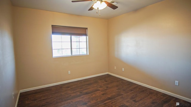 empty room with dark wood-type flooring and ceiling fan