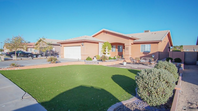 view of front of home featuring a garage and a front lawn