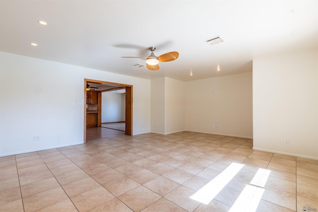 empty room featuring light tile patterned floors and ceiling fan