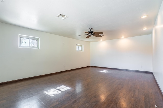 spare room with dark hardwood / wood-style floors and ceiling fan