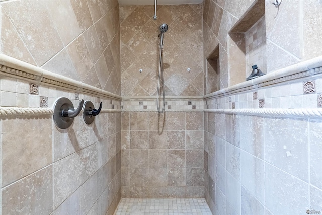 bathroom with a tile shower