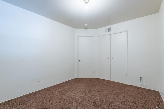 unfurnished bedroom featuring carpet floors and a closet