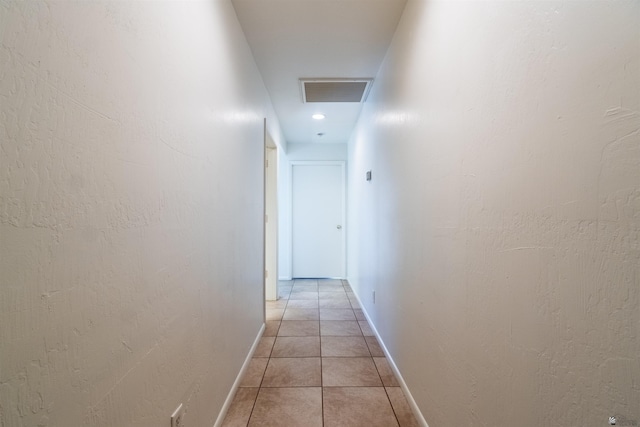 hall with light tile patterned floors