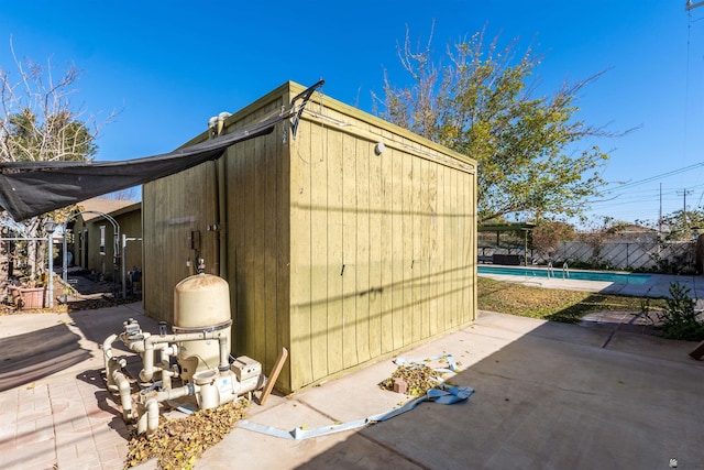 view of outdoor structure featuring a fenced in pool