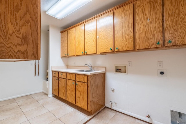 clothes washing area with gas dryer hookup, sink, cabinets, washer hookup, and electric dryer hookup