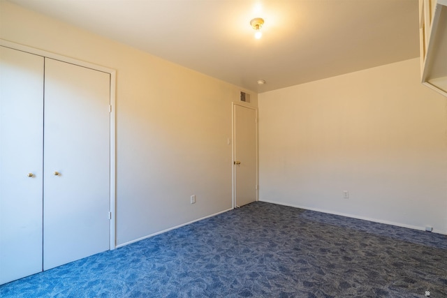 unfurnished bedroom with dark colored carpet