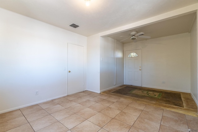 entrance foyer with light tile patterned floors and ceiling fan