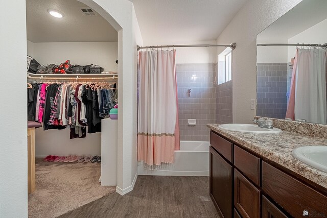 bathroom with vanity, shower / bath combination with curtain, and hardwood / wood-style flooring