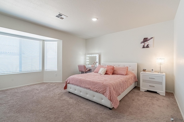 carpeted bedroom featuring a textured ceiling