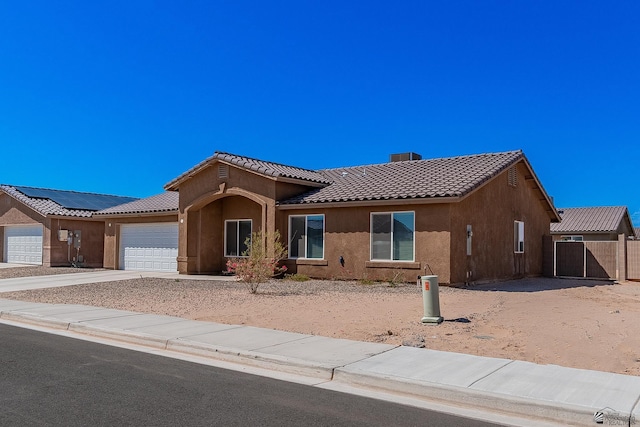 view of front of property with solar panels and a garage