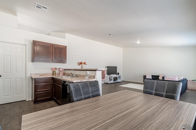 kitchen featuring dark brown cabinetry, sink, dark hardwood / wood-style flooring, and black dishwasher