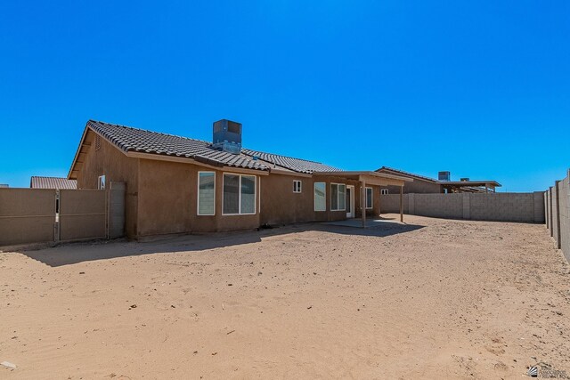 rear view of house featuring central air condition unit